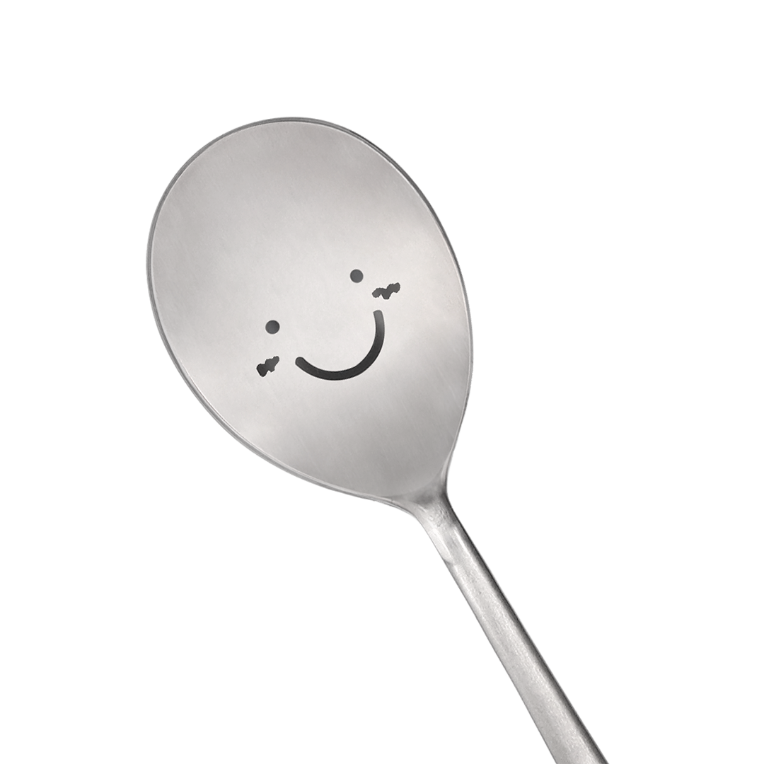 A spoon with a happy face is prominently in the center.